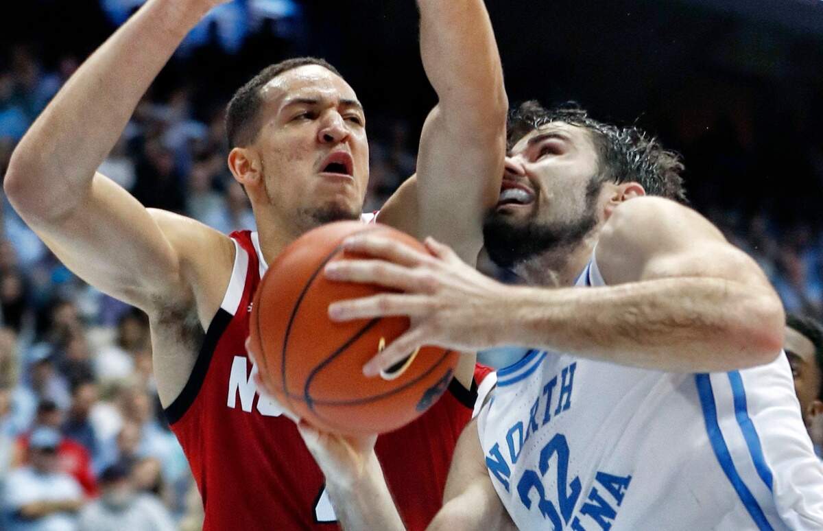 North Carolina’s Luke Maye (32) is fouled by N.C. State’s Jericole Hellems (4) during the first half of N.C. State’s game against UNC at the Smith Center in Chapel Hill, N.C. Tuesday, Feb. 5, 2019.