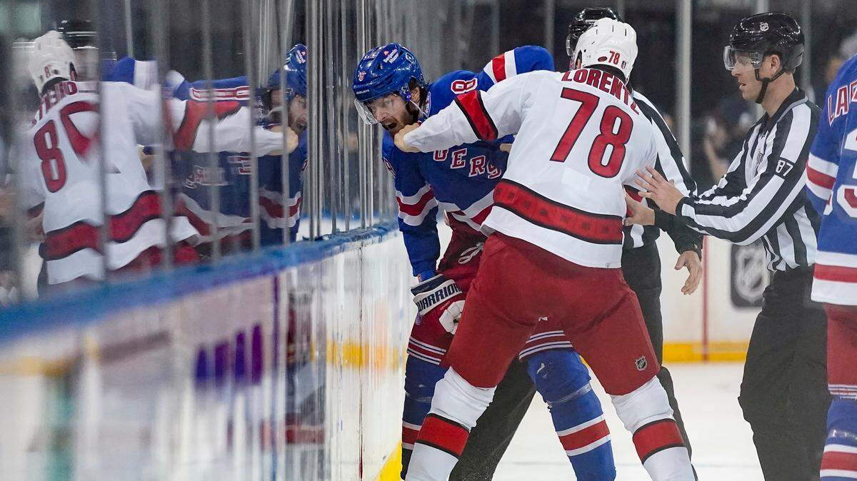 New York Rangers defenseman Jacob Trouba (8) and Carolina Hurricanes center Steven Lorentz (78) fight in the first period of Game 4 of an NHL hockey Stanley Cup second-round playoff series, Tuesday, May 24, 2022, in New York. (AP Photo/John Minchillo)