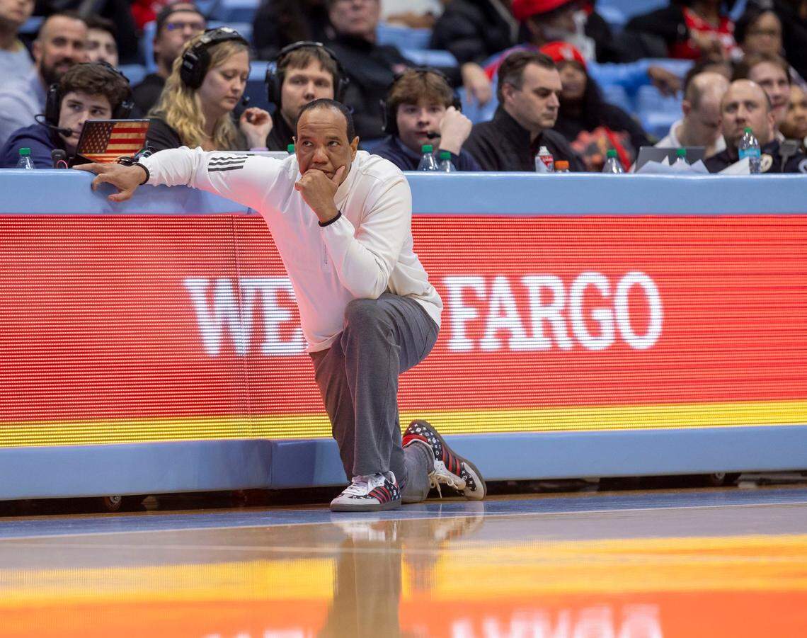 Down by 22 points to North Carolina, N.C. State coach Kevin Keatts takes a knee to watch the closing minutes of play on Wednesday, February 19, 2025 in Chapel Hill, N.C. 