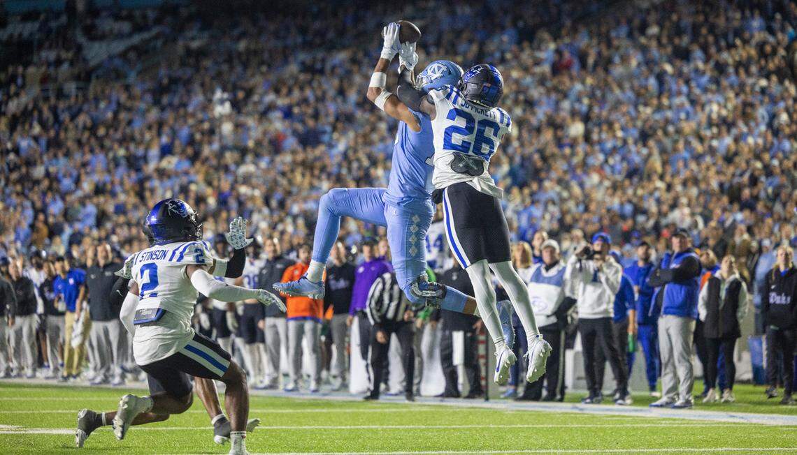 North Carolina’s Bryson Nesbit (18) pulls in a 15-yard pass from quarterback Drake Maye ahead of Duke’s Joshua Pickett (26) for a first down in the fourth quarter on Saturday, Nov. 11, 2023 at Kenan Stadium in Chapel Hill, N.C.