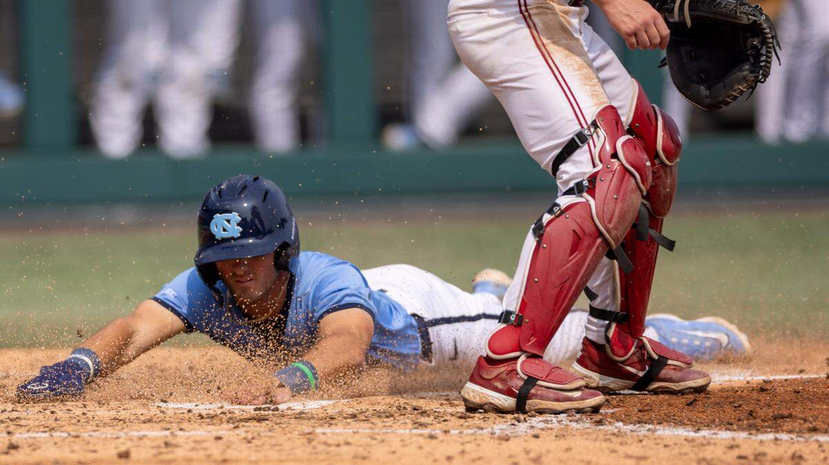 North Carolina short stop Alex Madera (1) slides into home to score on a single by Sam Angelo in the fourth inning to take 7-2 lead over Oklahoma during Game 7 of the NCAA Chapel Hill Regional on Monday, June 2, 2025 at Boshamer Stadium in Chapel Hill, N.C.