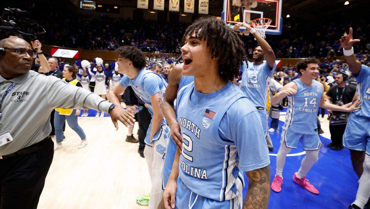 North Carolina players, including Elliot Cadeau (2) motion to the Cameron Crazies after UNC’s 84-79 victory over Duke at Cameron Indoor Stadium in Durham, N.C., Saturday, March 9, 2024.