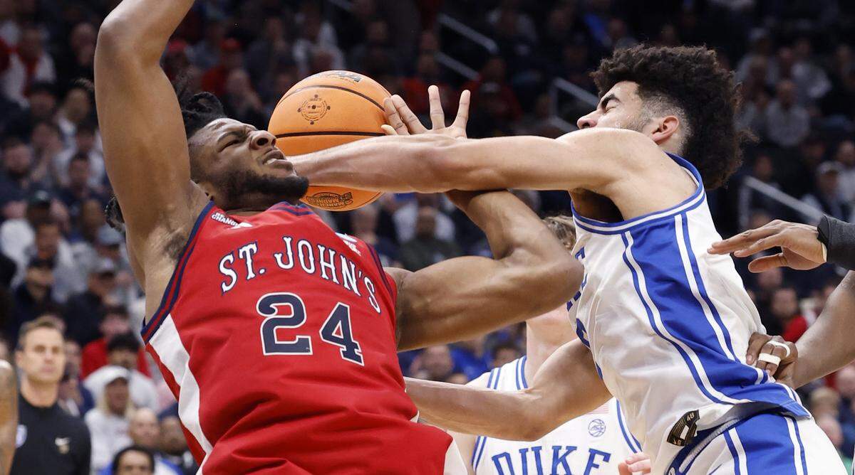 Duke’s Cayden Boozer (2) fouls St. John's Zuby Ejiofor (24) during the first half of Duke’s game against St. John’s in the Sweet 16 of the NCAA Men’s Basketball East Regional at Capital One Arena in Washington, D.C., Friday, March 27, 2026.
