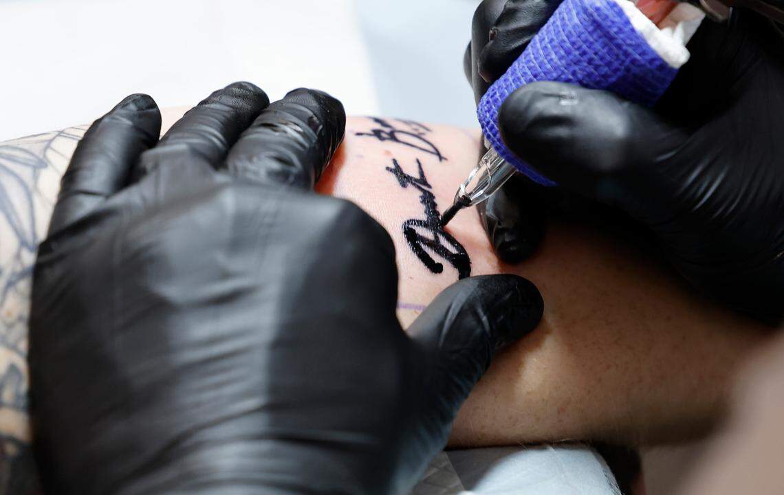 Danielle Christensen of Wendell gets the signature of Dante Bosco, who played Zuko on Avatar: The Last Airbender, tattooed on her arm at GalaxyCon in Raleigh, N.C., Saturday, July 27, 2024. The tattoo is part of GalaxyCon’s celebrity tattoo experience where you get a body part autographed by talent and then right afterward get the signature tattooed by River City Tattoo Company. “How can you pass up that opportunity?” said Christensen.