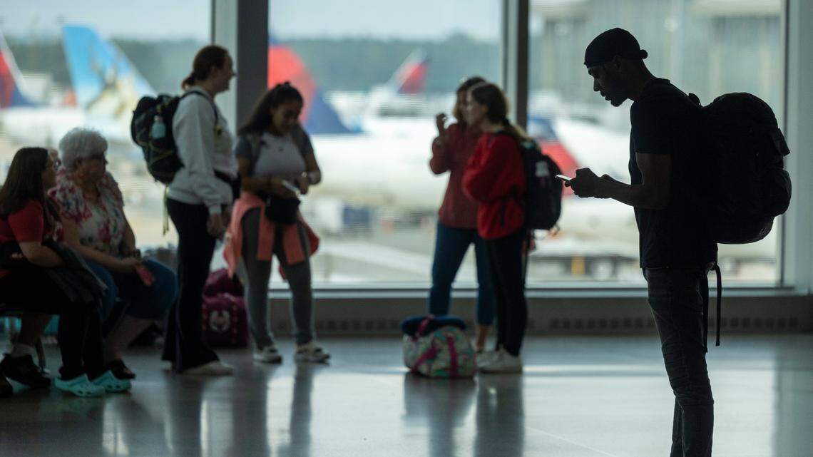 Passengers wait in Terminal 2 at RDU International Airport on Friday, July 19,2024 after a worldwide computer outage traced to a software update by the cybersecurity company CrowdStrike caused numerous canceled and delayed flights.