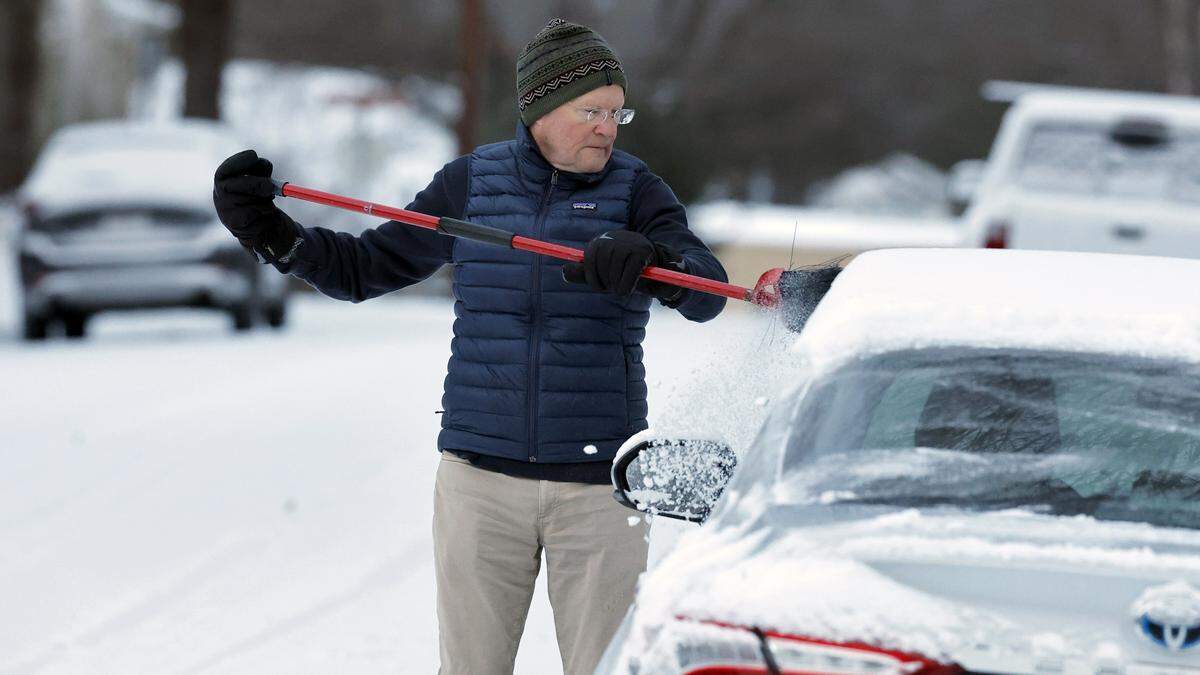 Former mayor Charles Meeker cleans off his vehicle in Raleigh, N.C., Sunday morning, Feb. 1, 2026.