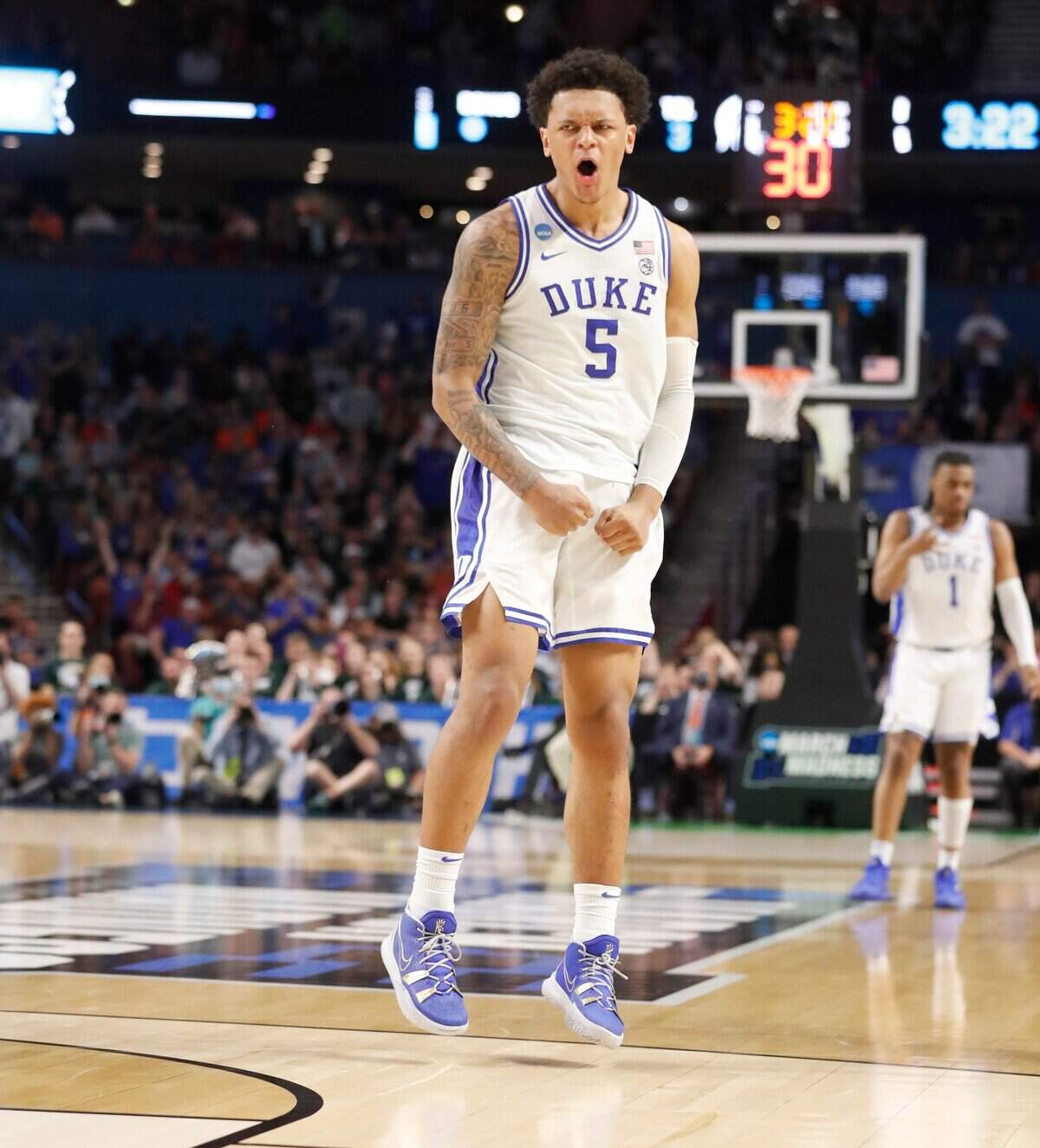 Dukes Paolo Banchero (5) celebrates after Trevor Keels hit a three-pointer during the second half of Dukes 85-76 victory over Michigan State in the second round of the NCAA Tournament at Bon Secours Wellness Arena in Greenville, S.C., Sunday, March 20, 2022.