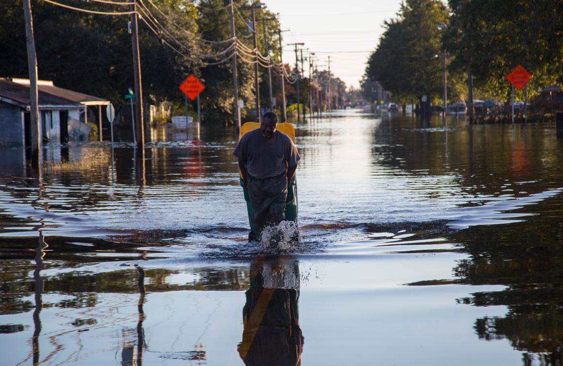 Lumberton resident Michael Anthony pulls a waste bin full of valuables that he retrieved from his flooded home after Hurricane Matthew caused downed trees, power outages, a municipal water outage and widespread flooding along the Lumber River Thursday, October 13, 2016 in Lumberton, NC.