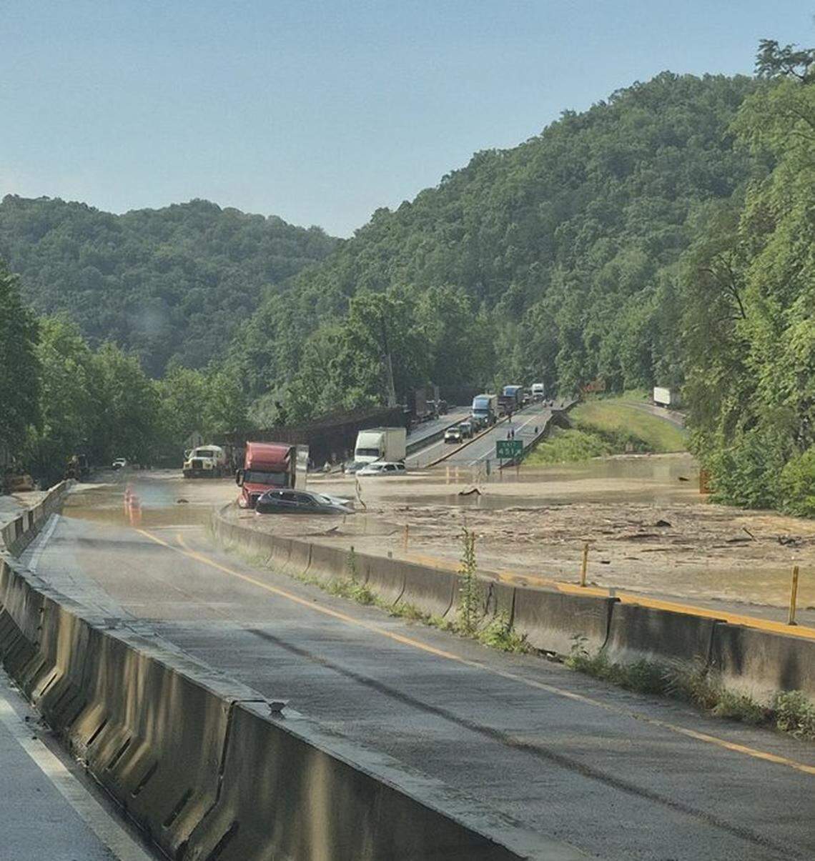 Cars and a tractor-trailer trapped in floodwaters on Interstate 40 at Exit 451 in Tennessee, just over the North Carolina state line on Wednesday, June 18, 2025.