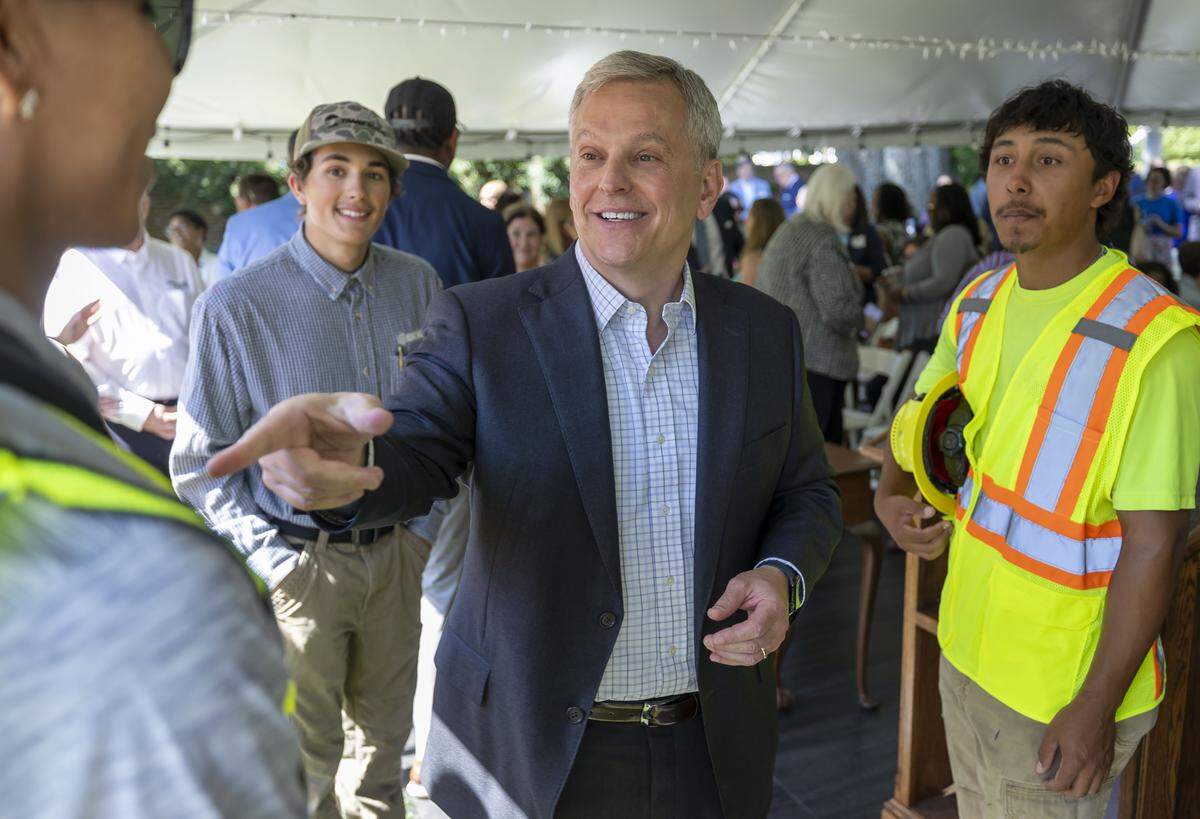 North Carolina Governor Josh Stein talks with David Hernandez, the winner of the North Carolina apprentice masonry contest, following Stein’s announcement of the new executive order. 
