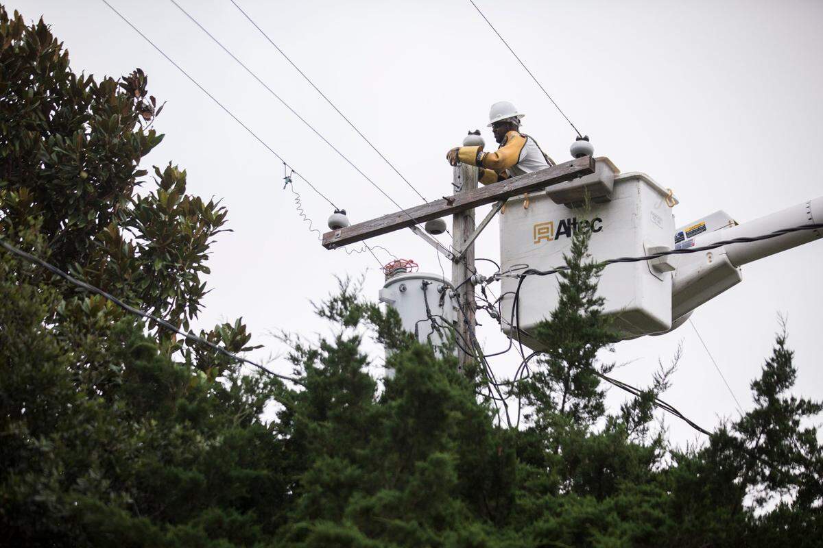 Contractors with the Carteret-Craven Electric Cooperative work on transformers in Pine Knoll Shores, N.C. on Tuesday morning, Aug. 4, 2020, hours after Hurricane Isaias, which later became a tropical storm, passed through the area causing several power outages but minimal damage.