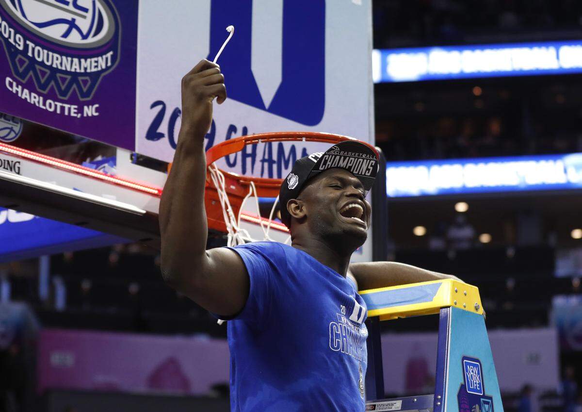 Duke’s Zion Williamson (1) celebrates after cutting the net after Duke’s 73-63 victory over Florida State in the finals of the 2019 ACC Tournament in Charlotte Saturday. Williamson scored 81 points in a three-game span in the tournament and played all but four seconds of the final