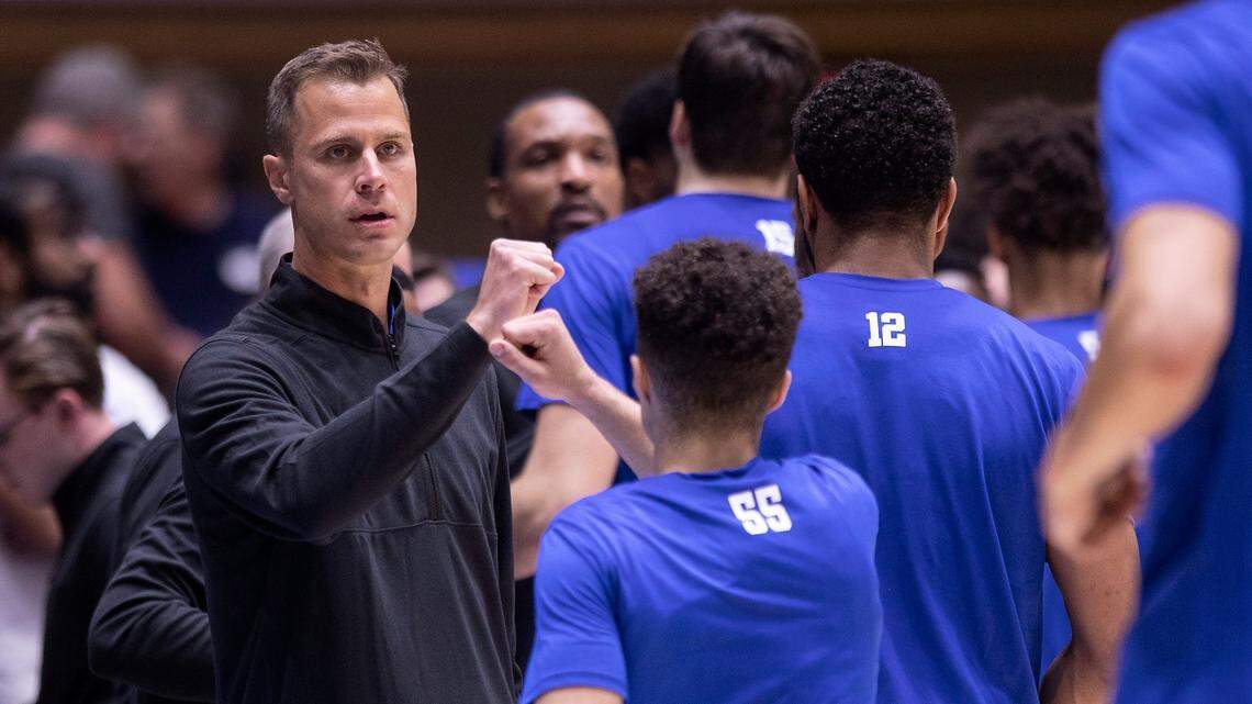 Duke head coach Jon Scheyer high fives players prior to the Blue Devils’ season opener against Jacksonville on Monday, Nov. 7, 2022, at Cameron Indoor Stadium in Durham, N.C.