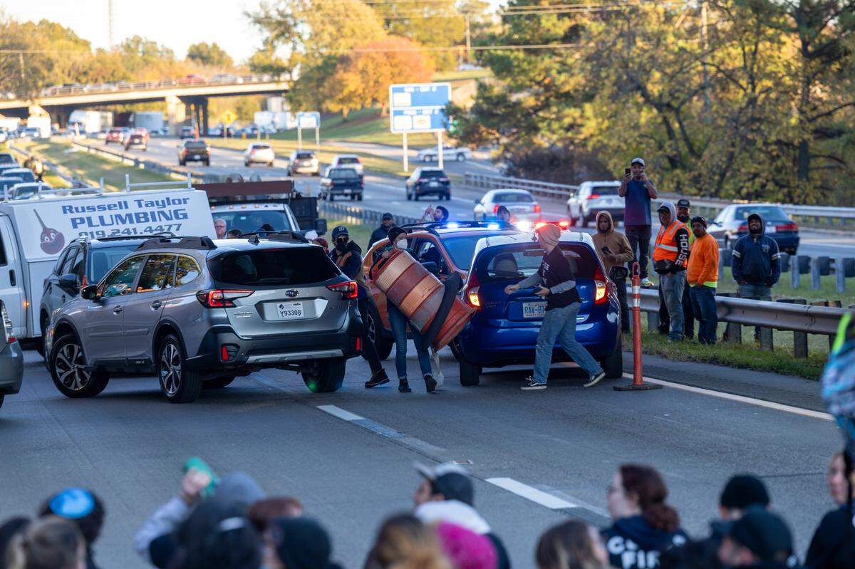 Protesters block the northbound lanes of the Durham Freeway at the South Magnum Street bridge for hours Thursday evening, Nov. 2, 2023 while demanding a ceasefire in the Israel-Gaza War as police warned of arrests.