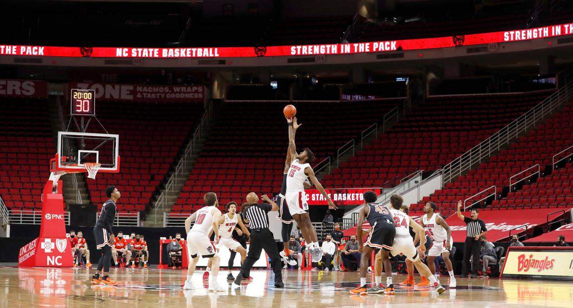N.C. State and Campbell tip-off in a mostly empty PNC Arena in Raleigh, N.C., Saturday, Dec. 19, 2020.