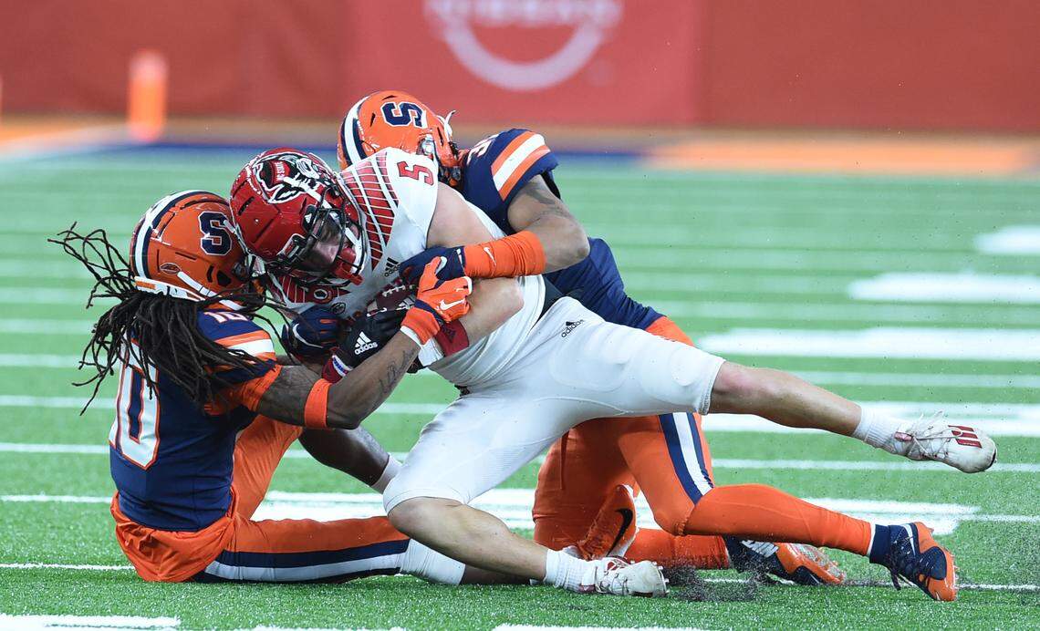 North Carolina State Wolfpack wide receiver Thayer Thomas (5) is tackled by Syracuse defenders during a game in the second half on Saturday, Nov. 28, 2020, at the Carrier Dome in Syracuse, N.Y. on Saturday, Nov. 28, 2020.