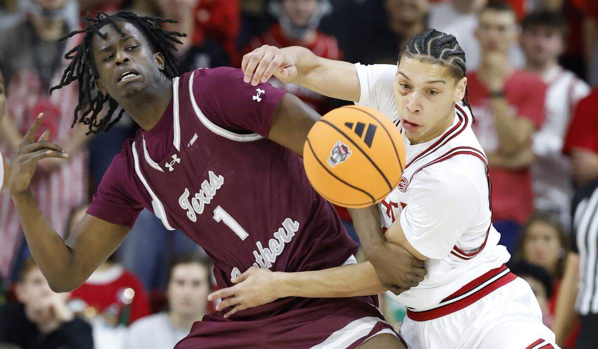 N.C. State's Matt Able (3) and Texas Southern's Oumar Koureissi (1) go after the ball during the first half of N.C. State’s game against Texas Southern at Reynolds Coliseum in Raleigh, N.C., Wednesday, Dec. 17, 2025.