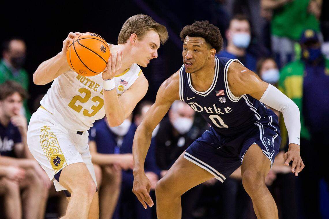 Notre Dame’s Dane Goodwin (23) gets pressure from Duke’s Wendell Moore Jr. (0) during the first half of an NCAA college basketball game Monday, Jan. 31, 2022, in South Bend, Ind. (AP Photo/Robert Franklin)