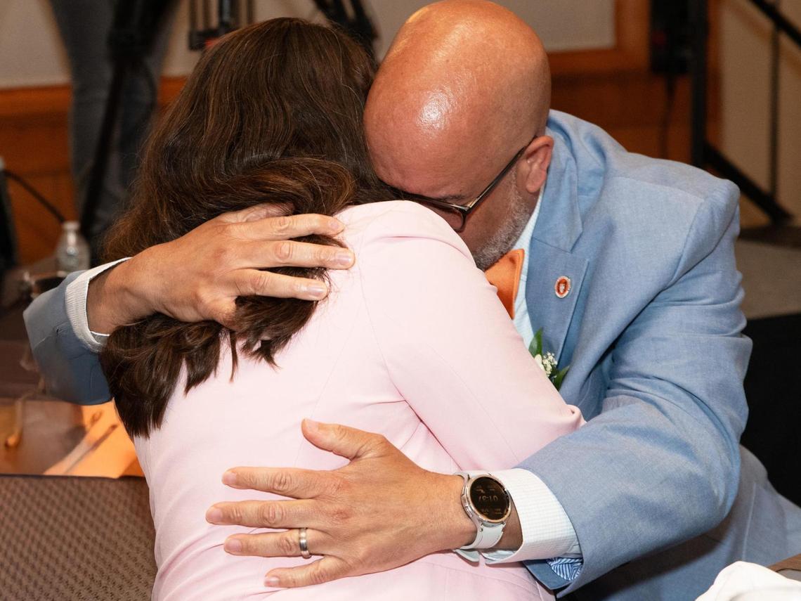 Orange High School Principal Jason Johnson hugs his wife Heather Johnson, a literacy instructor at A.L. Stanback Middle School after being named the 2025 Wells Fargo Principal of the Year during a May 16, 2025, ceremony in Cary, NC.