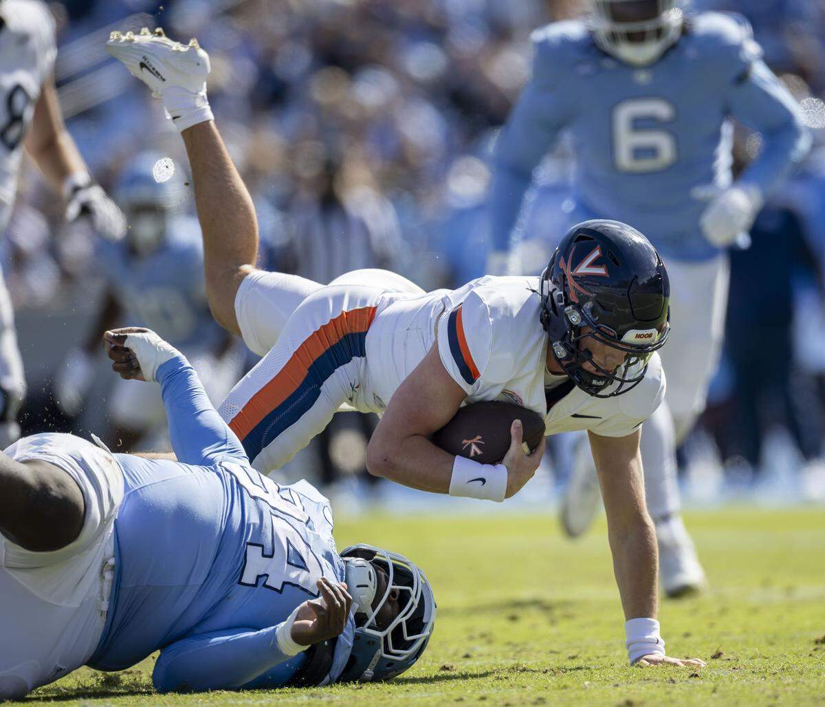 North Carolina defensive lineman Isiah Johnson (94) sacks Virginia quarterback Chandler Morris (4) for a 15 yard loss in the second quarter on Saturday, October 25, 2025 at Kenan Stadium in Chapel Hill, N.C. 
