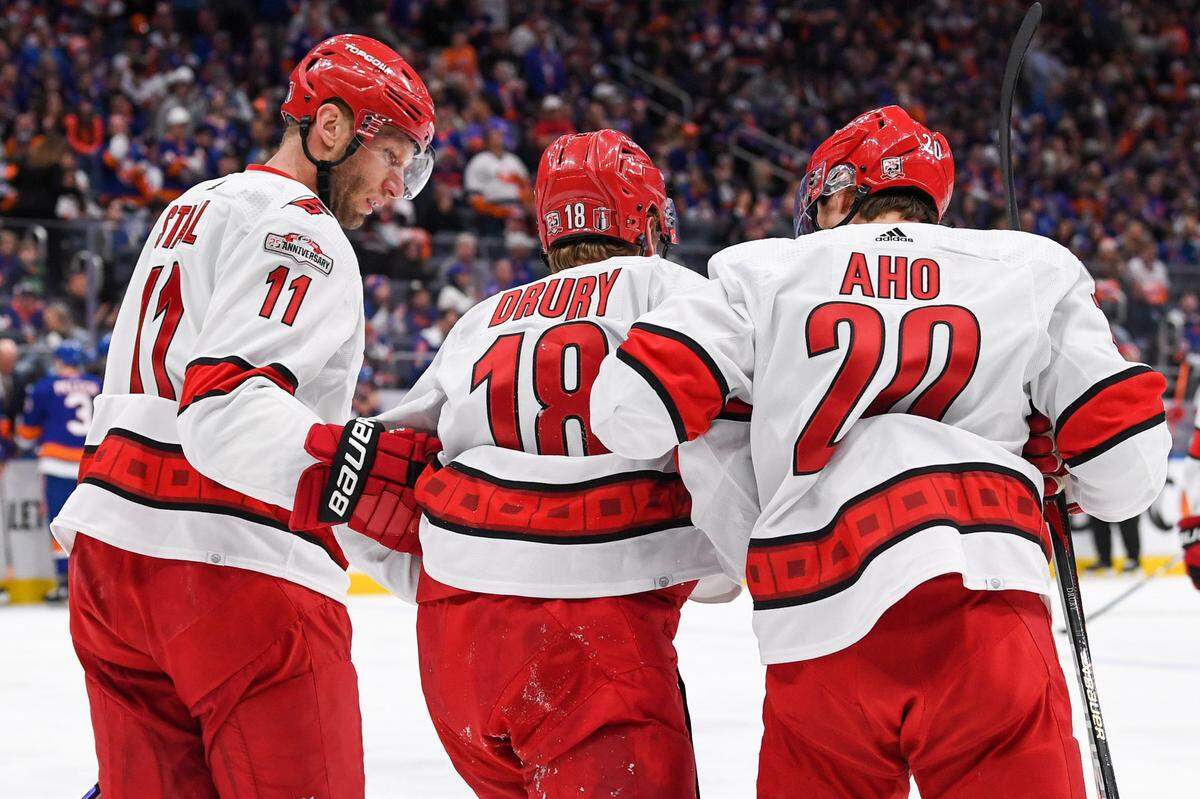 Apr 23, 2023; Elmont, New York, USA; Carolina Hurricanes center Jordan Staal (11) and Carolina Hurricanes center Sebastian Aho (20) help Carolina Hurricanes center Jack Drury (18) off the ice after an injury against the New York Islanders during the first period in game four of the first round of the 2023 Stanley Cup Playoffs at UBS Arena. Mandatory Credit: Dennis Schneidler-USA TODAY Sports