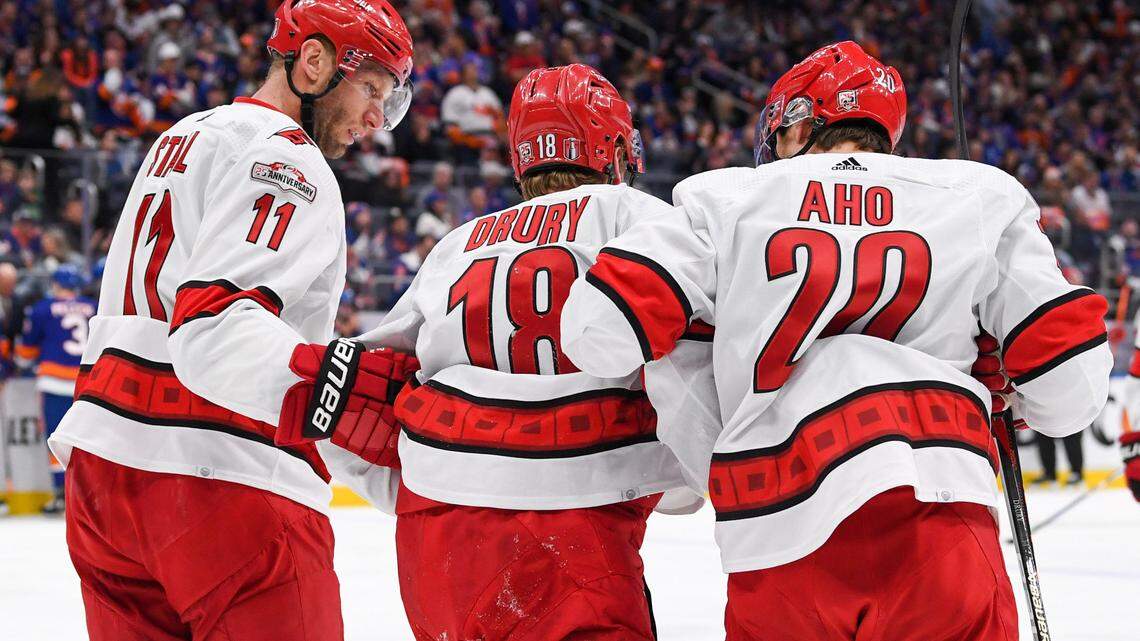 Carolina Hurricanes center Jordan Staal (11) and Carolina Hurricanes center Sebastian Aho (20) help Carolina Hurricanes center Jack Drury (18) off the ice after an injury against the New York Islanders during the first period in game four of the first round of the 2023 Stanley Cup Playoffs at UBS Arena.