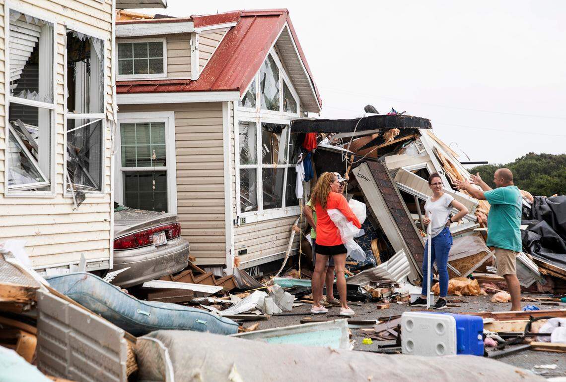 Residents of the Boardwalk RV Park in Emerald Isle, NC discuss the path of Hurricane Dorianís waterspout after it ripped through their community on Thursday, Sept. 5, 2019.