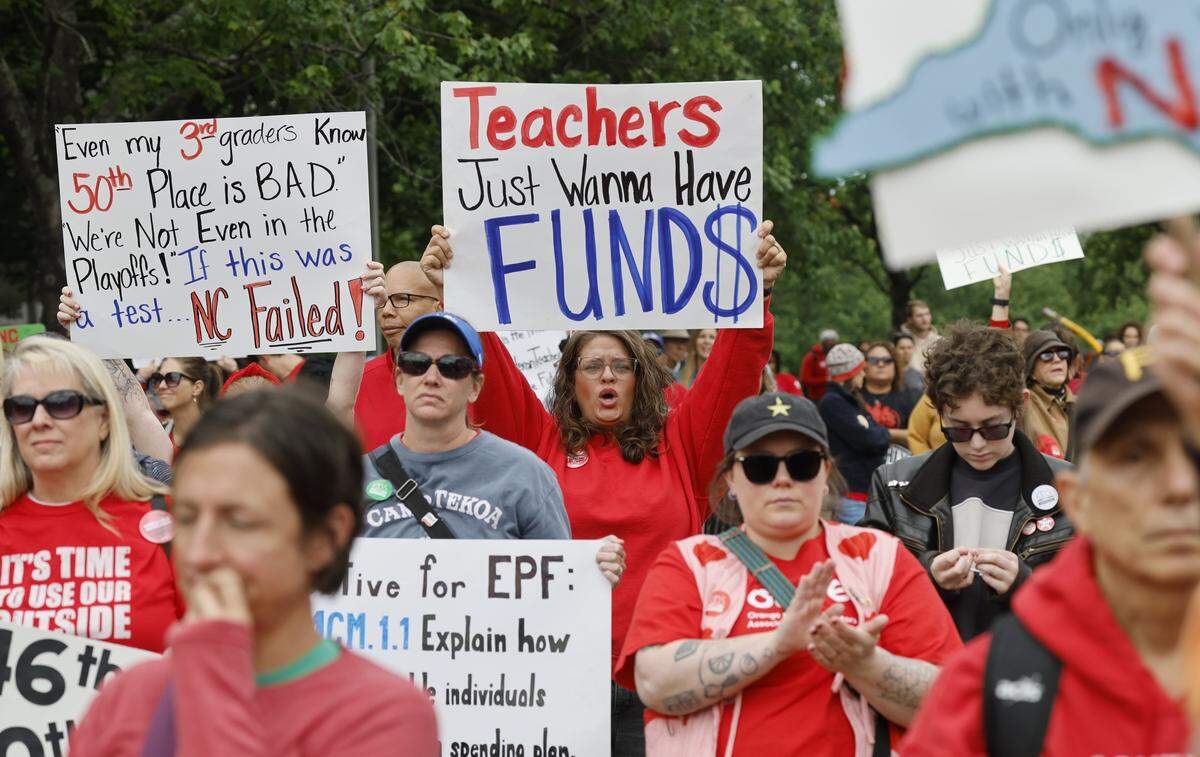 People cheer on the speakers during a rally to protest for more school funding at Halifax Mall in downtown Raleigh, N.C., Friday, May 1, 2026.  The North Carolina Association of Educators has mobilized teachers from across the state to march on the Legislative Building to demand higher pay, more school funding and higher taxes on corporations. 