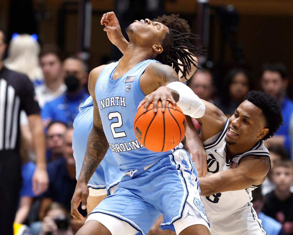 North Carolina’s Caleb Love (2) drives around Duke’s Jeremy Roach (3) during the second half of Duke’s 63-57 victory over UNC at Cameron Indoor Stadium in Durham, N.C., Saturday, Feb. 4, 2023.