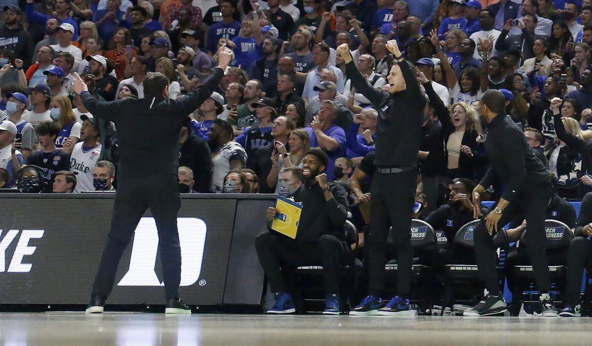 Duke head coach Mike Krzyzewski, left, celebrates with the crowd near the end of Duke’s 85-76 victory over Michigan State in the second round of the NCAA Tournament at Bon Secours Wellness Arena in Greenville, S.C., Sunday, March 20, 2022.