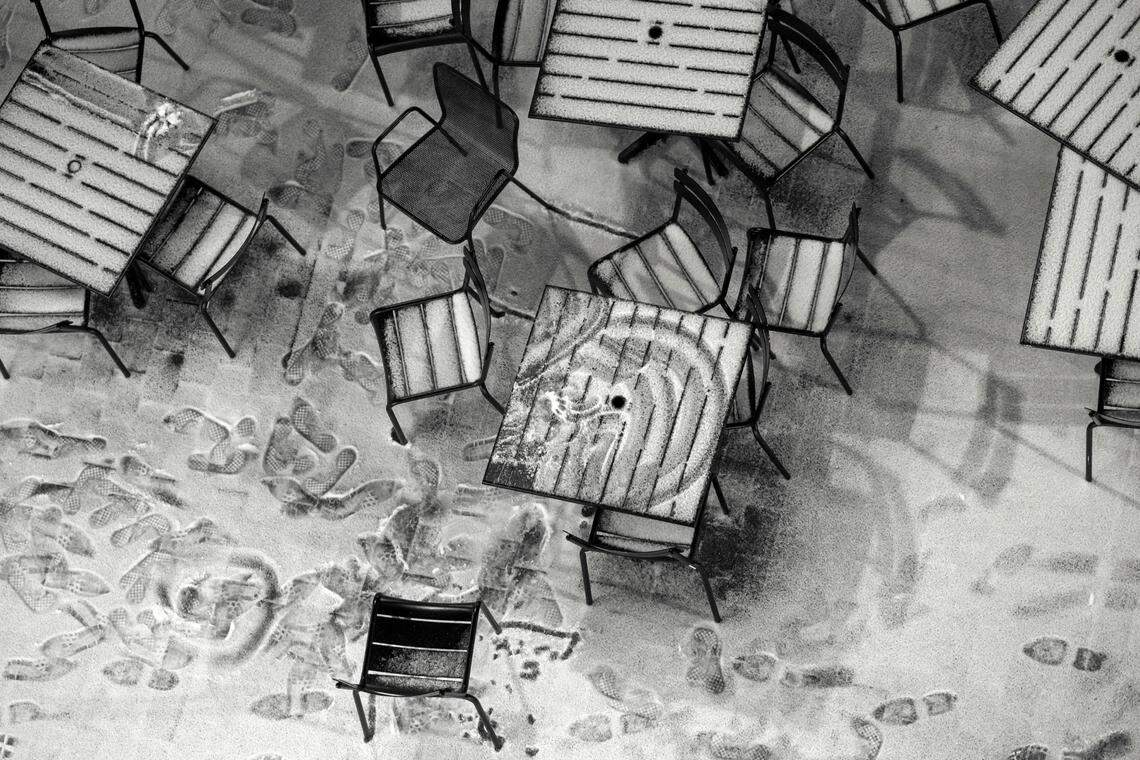 Tables and chairs for street side dinning are covered with a dusting of snow on Friday, January, 10, 2025 in Raleigh, after a winter storm moved across the state delivering a wintry mix.