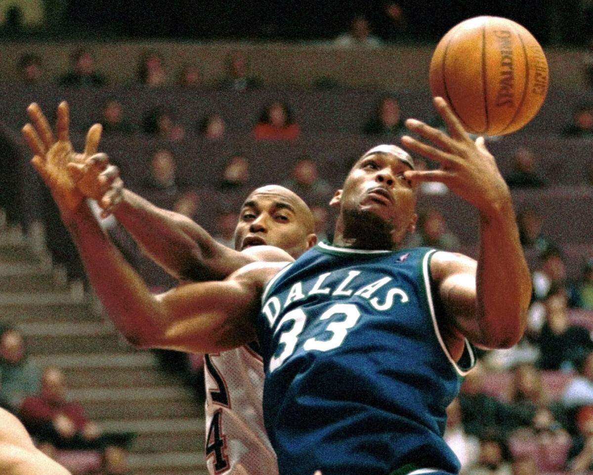 Dallas Mavericks' Gary Trent, right, battles New Jersey Nets' Scott Burrell for the ball on March 17, 1999 in East Rutherford, N.J.