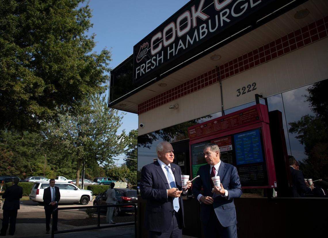 Democratic Vice Presidential nominee and Minnesota Gov. Tim Walz orders a Cook Out milkshake with Gov. Roy Cooper during a visit to Raleigh, N.C. on Thursday, Aug. 29, 2024.