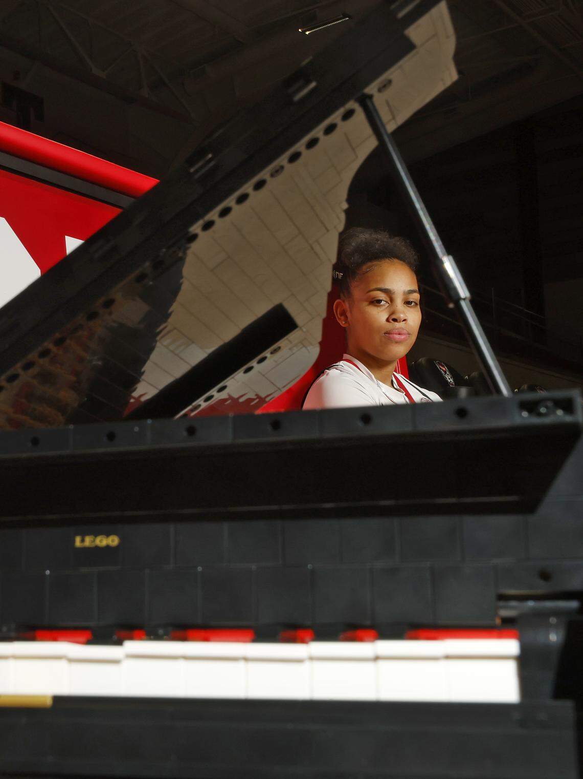N.C. State sophomore guard Zamareya Jones, photographed on Saturday, Jan. 3, 2026, at Reynolds Coliseum, poses for a portrait with a Grand Piano Lego set she constructed.