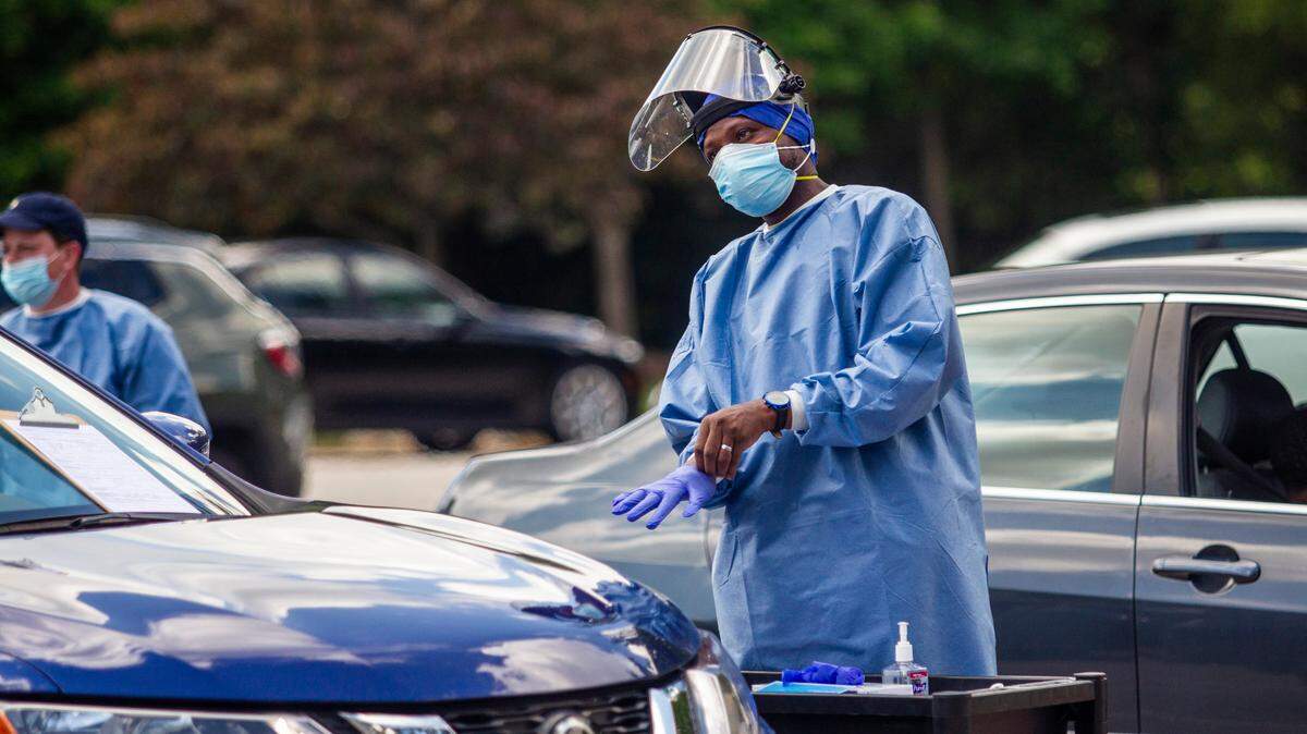 Gandhi Elamin conducts a coronavirus test at the Avery Street Recreation Center in Garner Friday, July 10, 2020. About 400 people received tests at the pop up testing site.