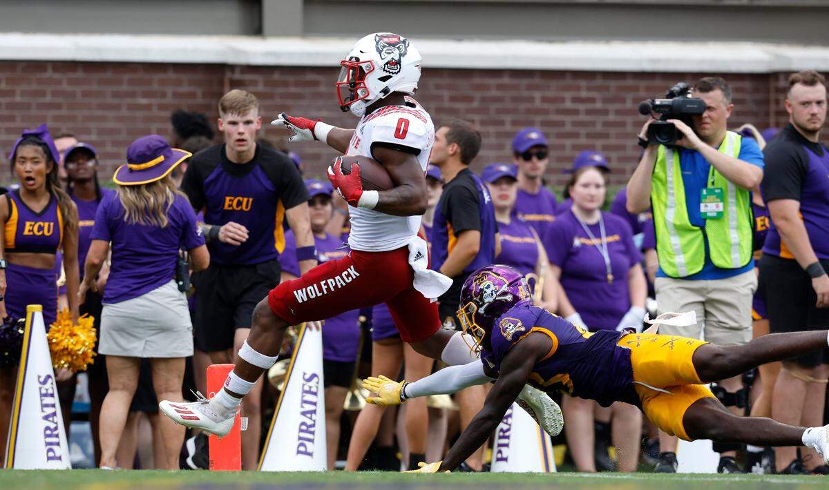 N.C. State running back Demie Sumo-Karngbaye (0) beats East Carolina cornerback Damel Hickman (23) to score on a 24-yard touchdown run during the first half of N.C. States game against ECU at Dowdy-Ficklen Stadium in Greenville, N.C., Saturday, Sept. 3, 2022.