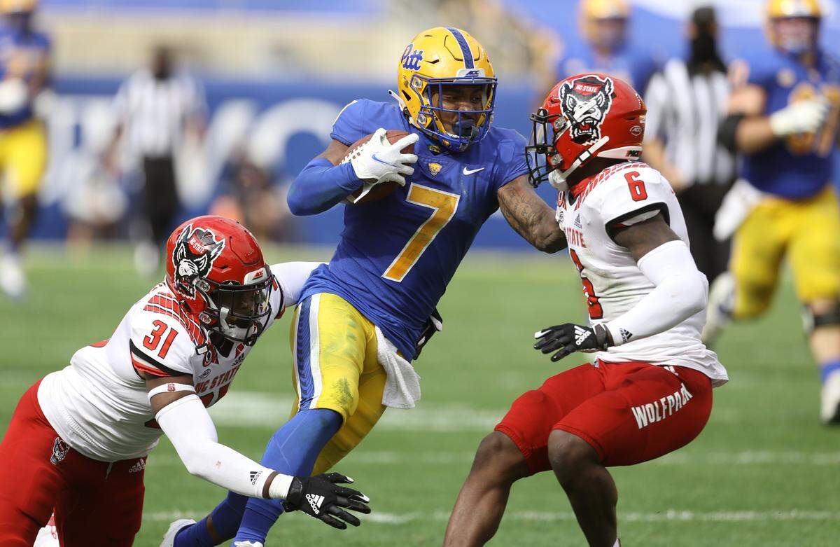 Pittsburgh Panthers wide receiver DJ Turner (7) runs after a catch N.C. State’s Vi Jones (31) and Jakeen Harris (6) try to tackle him during the Wolfpack’s game against the Panthers at Heinz Field in Pittsburgh, PA, Saturday, Oct. 3, 2020.