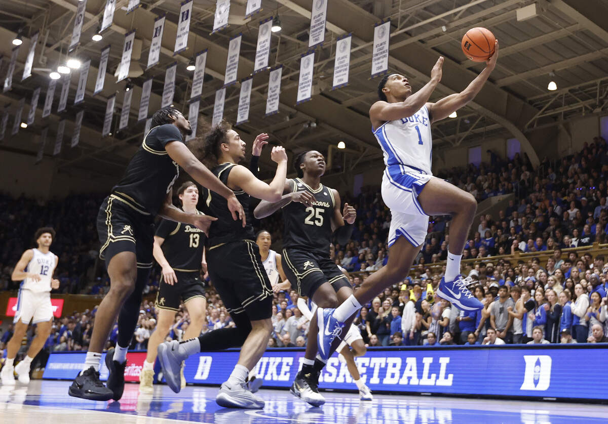 Duke’s Caleb Foster (1) beats the Wake Forest defenders on a drive to the basket during Duke’s 90-69 victory over Wake Forest at Cameron Indoor Stadium in Durham, N.C., Saturday, Jan. 24, 2026.