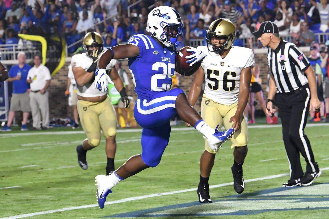 Duke running back Deon Jackson (25) skips into the end zone as Army linebacker Kenneth Brinson (56) looks on in the third quarter. Duke opened the 2018 football season with a win against Army 34-14 at Wallace Wade Stadium in Durham, N.C., Friday, August 31, 2018.