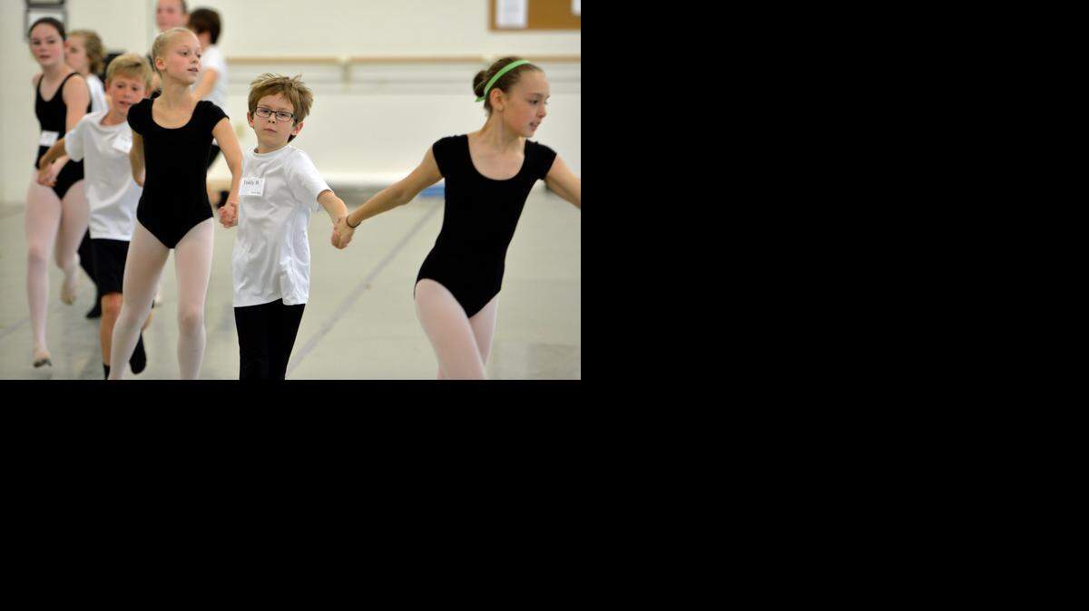 Teddy Barzyk, middle, dances with Anna Socha, left, and Tillie Spoor during a rehearsal of the Carolina Ballet’s production of “The Nutcracker.”