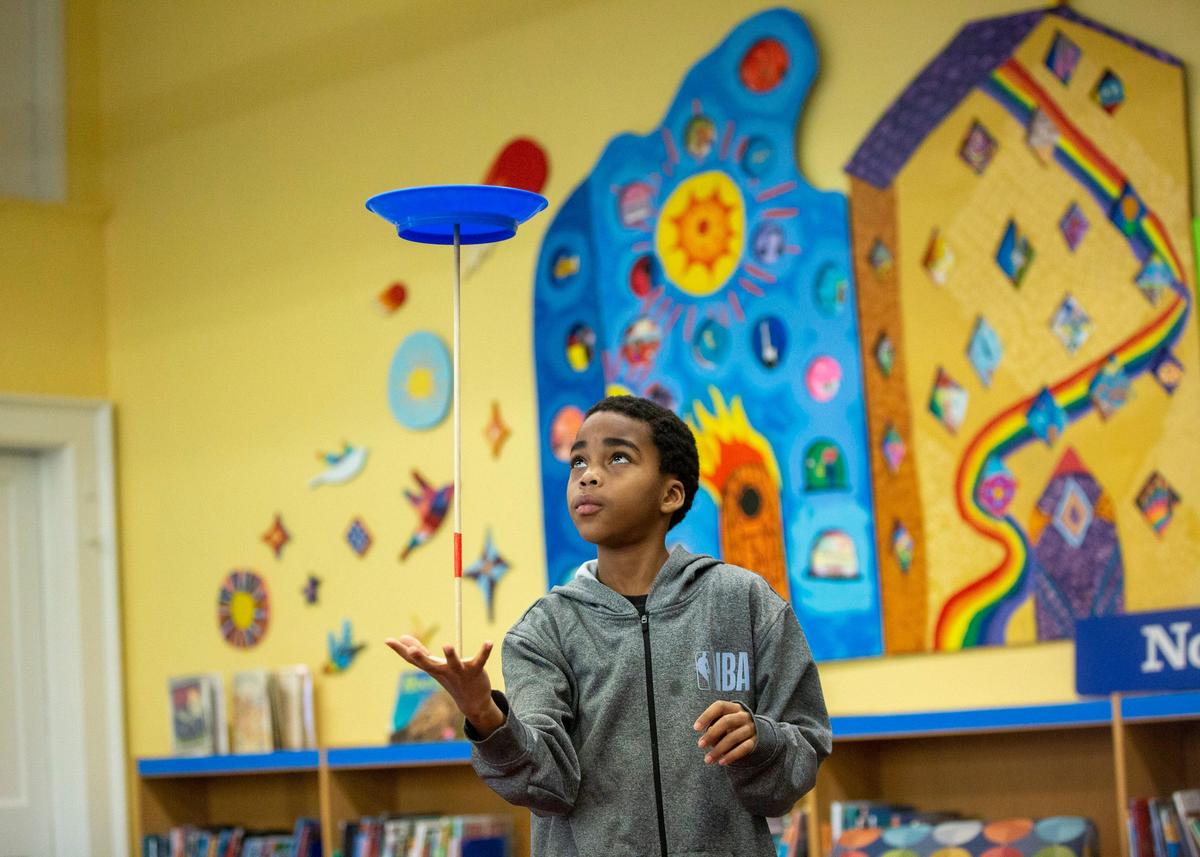Delreese Glover performs with his spinning plates during the Magnet Theme Showcase at Washington Magnet Elementary School, where parents learn about what the school may offer their child if they are accepted, on Tuesday, Jan. 14, 2020, in Raleigh, N.C.
