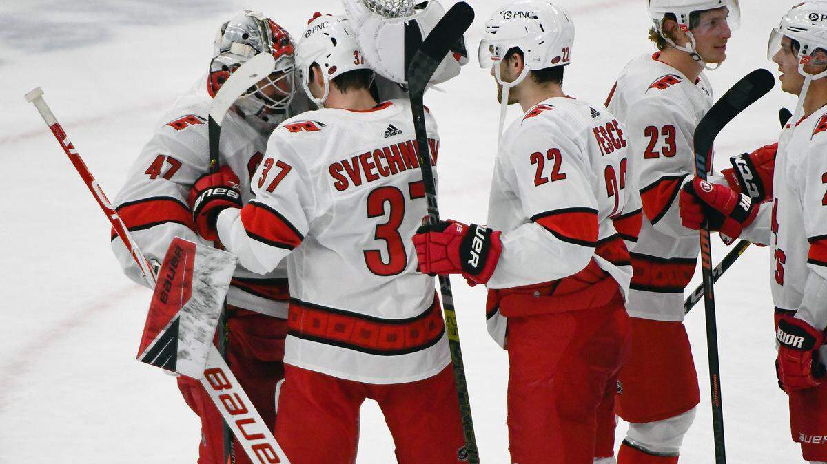 Carolina Hurricanes right wing Andrei Svechnikov (37) is hugged by Carolina Hurricanes goaltender James Reimer (47) after Svechnikov scored a shootout winning goal during overtime of an NHL hockey game against the Chicago Blackhawks, Tuesday, Feb. 2, 2021, in Chicago. (AP Photo/Matt Marton)