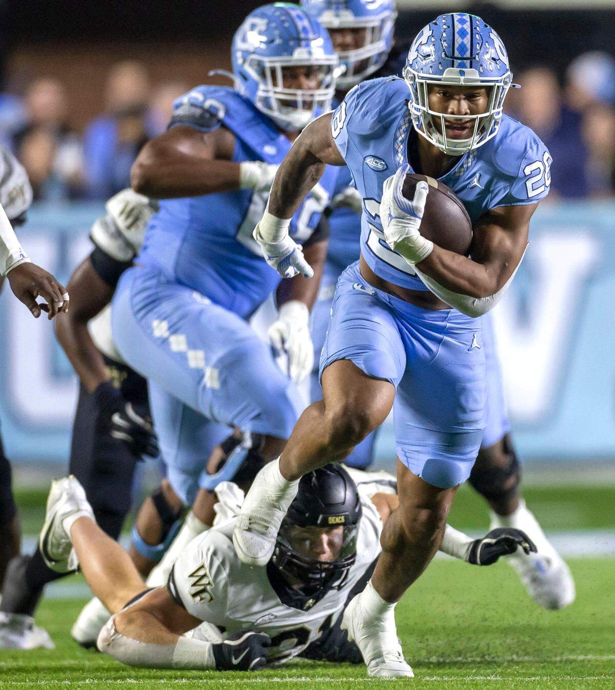 North Carolina running back Omarion Hampton (28) looks for running room on a 20-yard run in the first quarter against Wake Forest on Saturday, November 16, 2024 at Kenan Stadium in Chapel Hill, N.C.