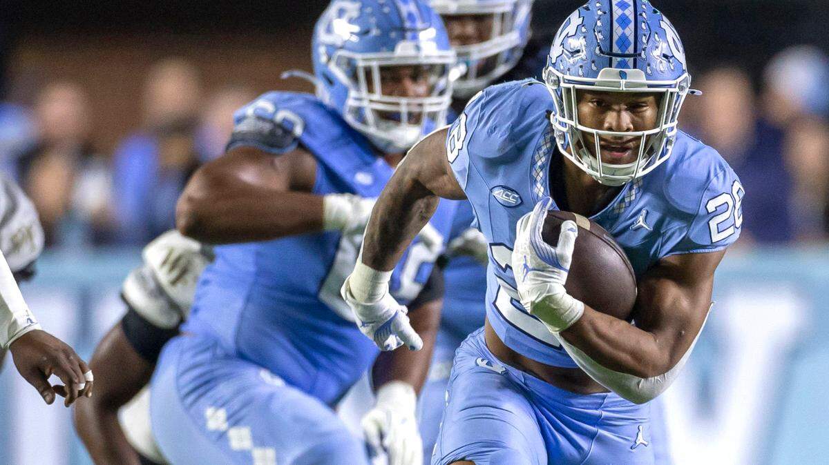 North Carolina running back Omarion Hampton (28) looks for running room on a 20-yard run in the first quarter against Wake Forest on Saturday, November 16, 2024 at Kenan Stadium in Chapel Hill, N.C.