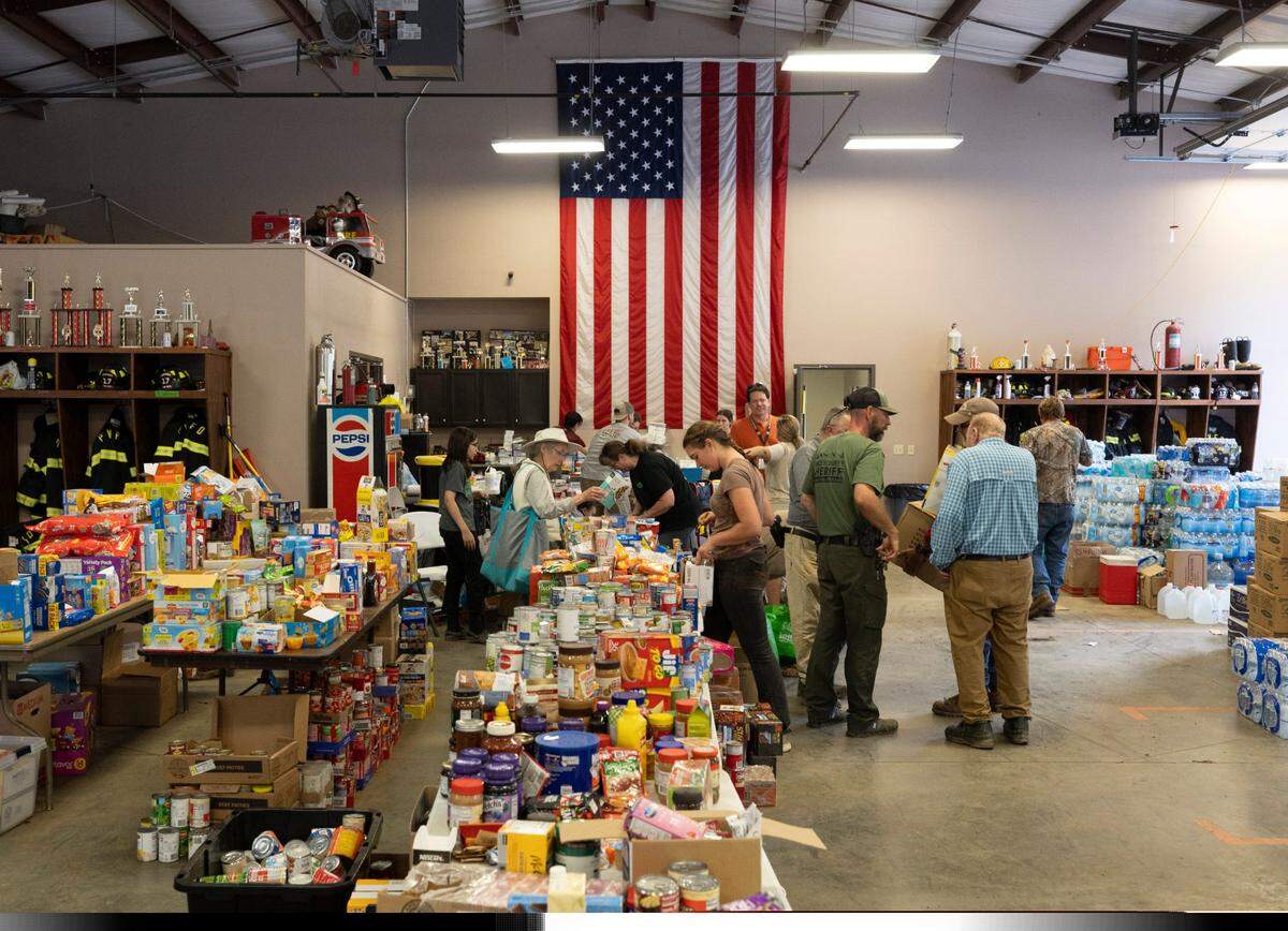 Inside the Pensacola Fire Department on Thursday, October 3, 2024, volunteers sort donations to the community that was hard hit by Hurricane Helene The storm destroyed roads, cutting off access to the Yancey County, N.C. community. Most supplies have been flown in by helicopter or driven in on four wheel drive vehicles.