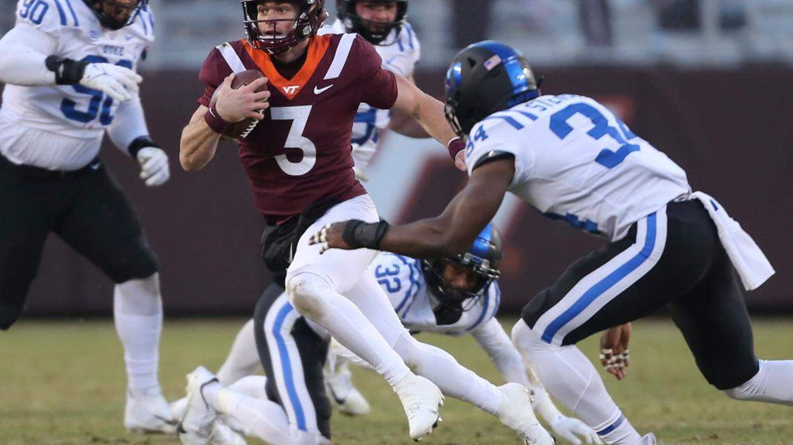 Virginia Tech quarterback Braxton Burmeister (3) runs the ball while defended by Duke’s Jalen Alexander (32) and Sayyid Stevens (34) in the first half of an NCAA college football game in Blacksburg Va., Saturday, Nov. 13 2021. (Matt Gentry/The Roanoke Times via AP)
