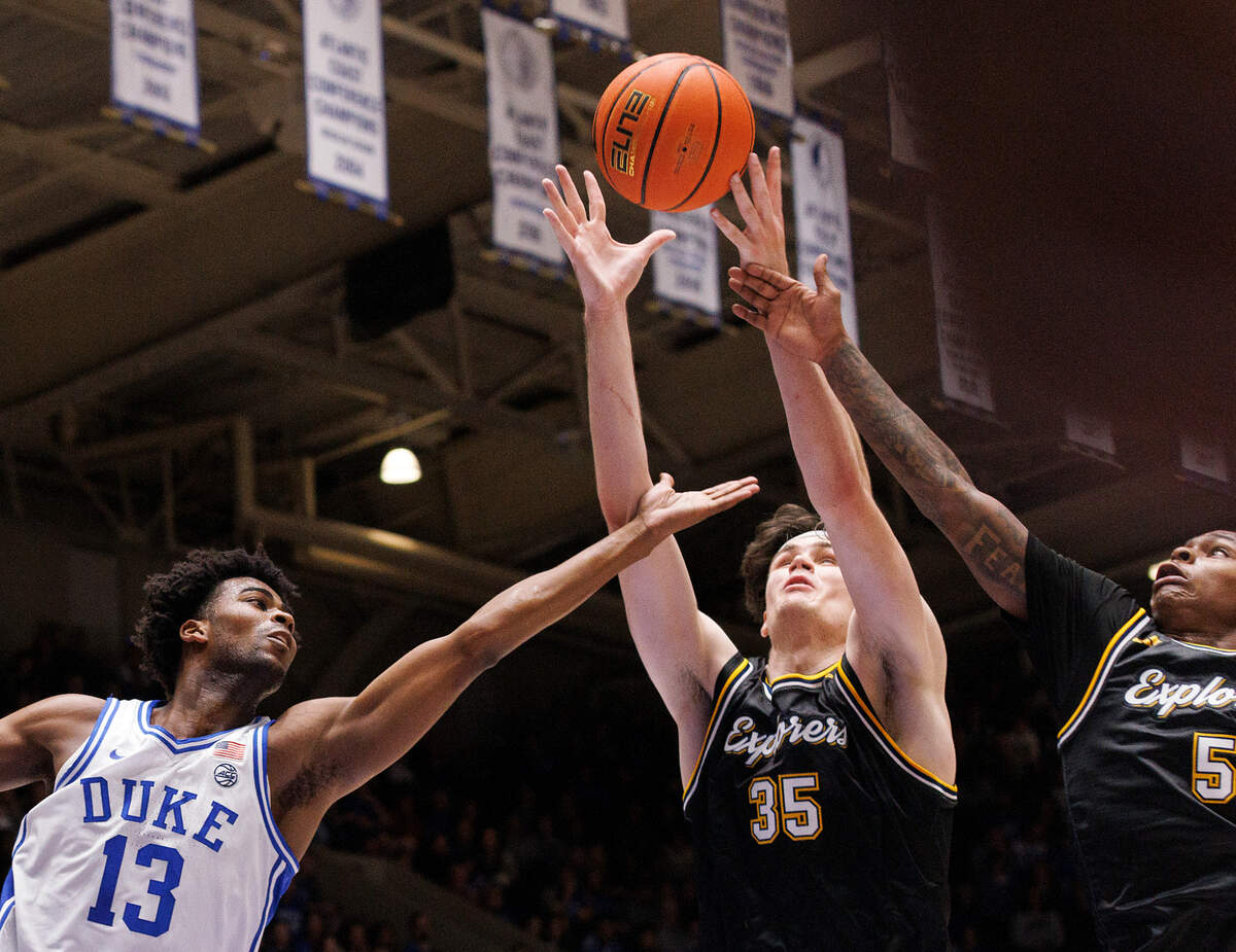 Duke’s Sean Stewart lunges for a rebound with La Salle’s Rokas Jocius and Khalil Brantley during the second half of the Blue Devils’ 95-66 win on Tuesday, Nov. 21, 2023, at Cameron Indoor Stadium in Durham, N.C.
