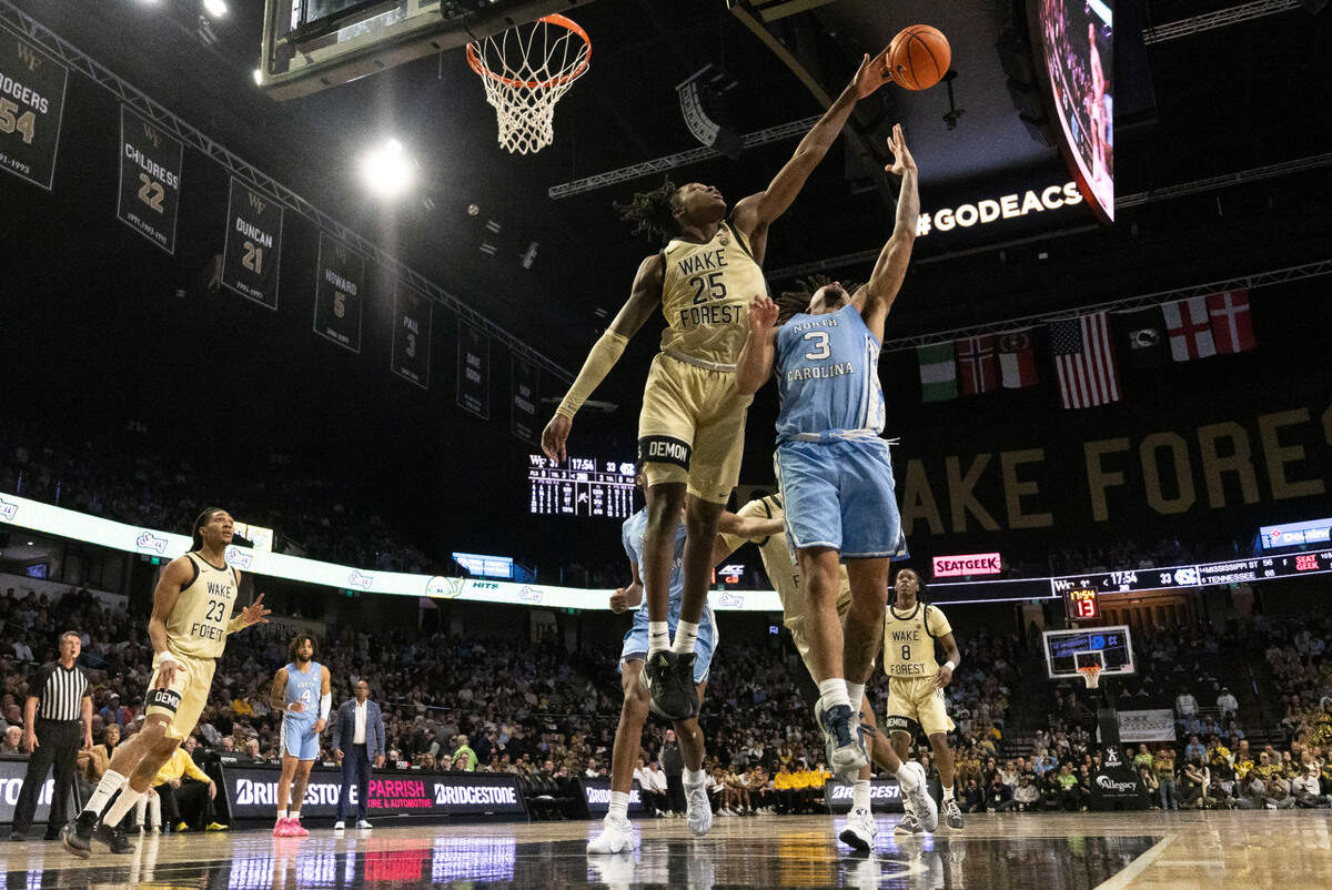 Wake Forest’s Tre’Von Spillers (25) blocks a shot by North Carolina guard Elliot Cadeau (3) in the second half on Tuesday, January 21, 2025 at Lawrence Joel Coliseum in Winston-Salem, N.C.