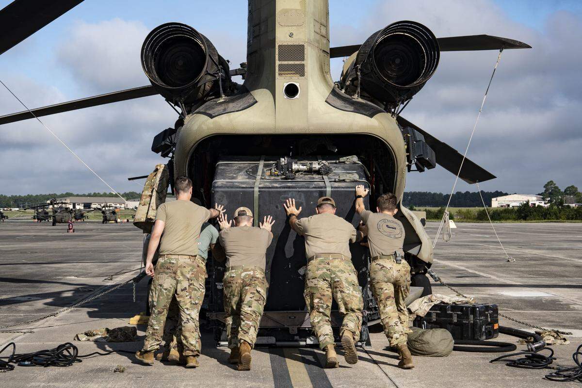 Paratroopers assigned to the 82nd Combat Aviation Brigade load a CH-47 Chinook before departing Simmons Army Airfield at Fort Liberty, North Carolina, Oct. 2, 2024.