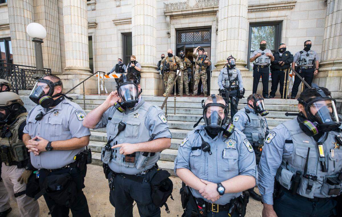 Alamance County sheriff’s deputies prepare to arrest participants in the march to the polls rally outside the Alamance County Historic Courthouse in Graham, N.C. after pepper spraying the crowd on Saturday, October 31, 2020.